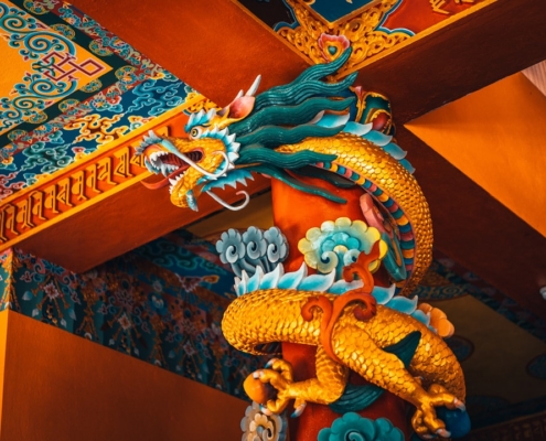 blue dragon figurine on brown wooden table