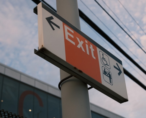 Exit sign points the way.