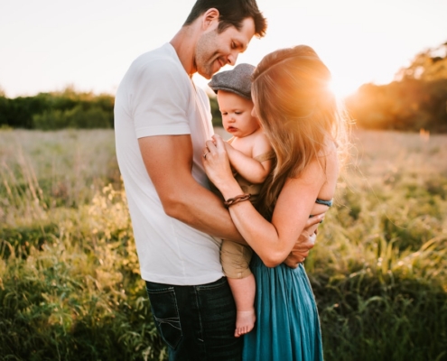 family photo on green grass during golden hour