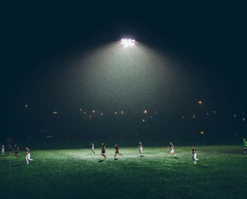 group of people playing soccer on soccer field