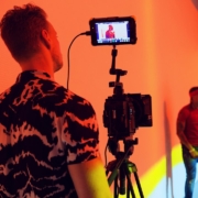 man in black and white shirt holding camera