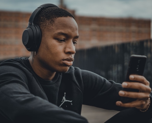man in black nike hoodie wearing black headphones