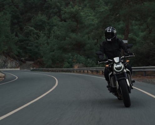 man riding motorcycle on concrete street