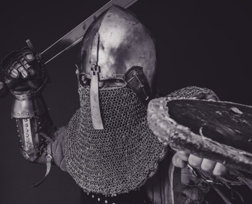 man with steel and chainmail armor holding sword
