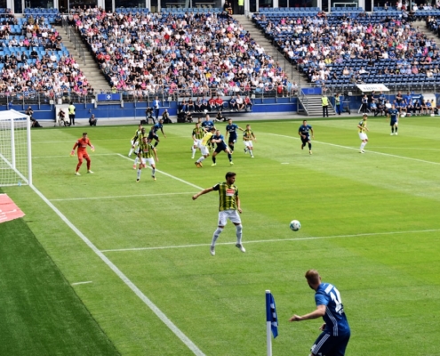 men playing soccer of soccer field during daytime
