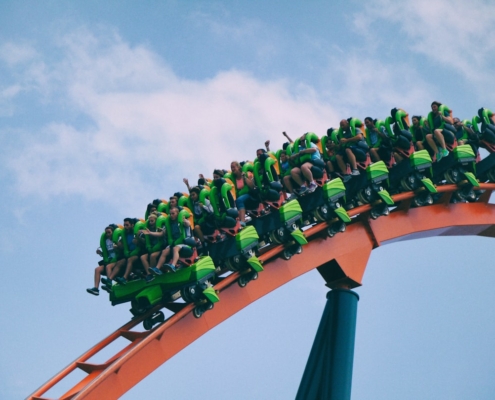 people riding on roller coaster