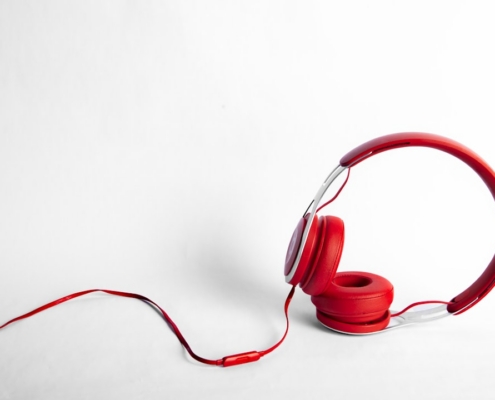 red and gray corded headphones
