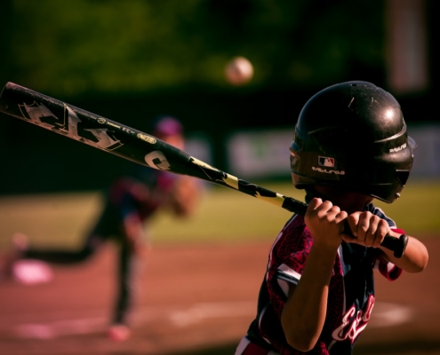 selective focus photography of person holding baseball bat