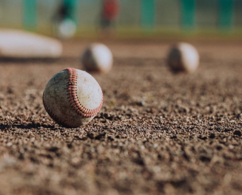 selective focus photography of white baseball balls on ground