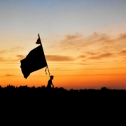silhouette of a flag on a pole during sunset
