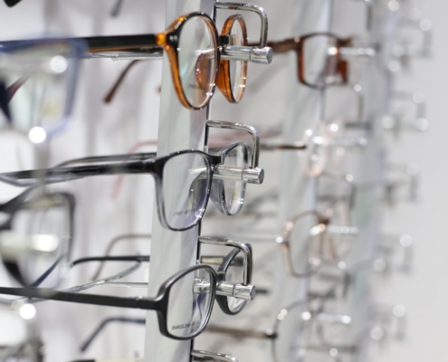 silver framed eyeglasses on clear glass