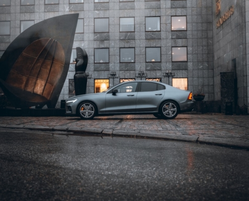 silver sedan parked beside building