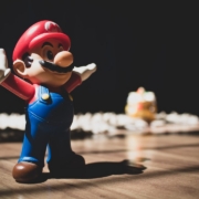 Super Mario figurine on brown surface