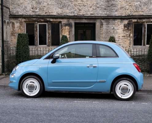 teal 3-door hatchback on road