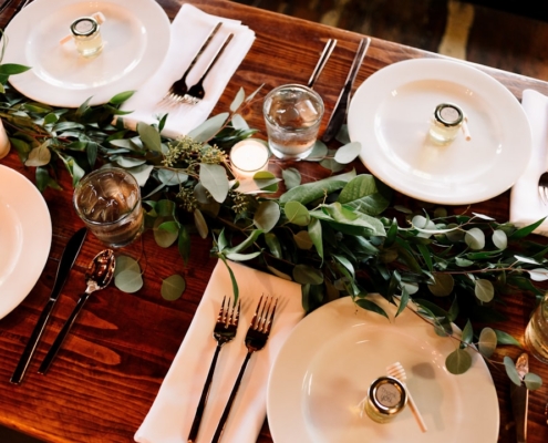 white ceramic dinner plate set on brown wooden table