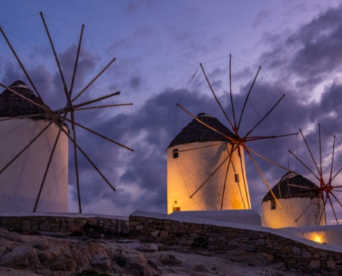 white wind turbines on brown rocky mountain under white cloudy sky during daytime