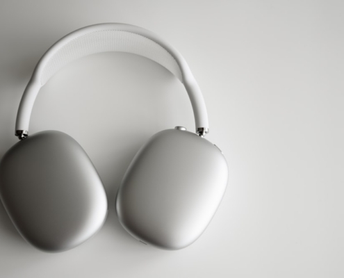 white wireless headphones on white table