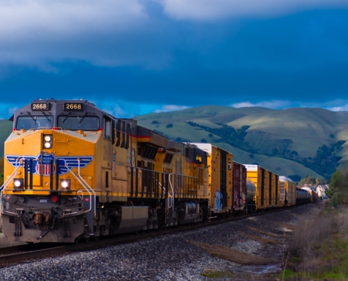 yellow and black train near mountain