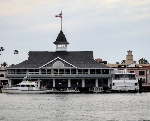 a boat dock with a building and a flag on top of it