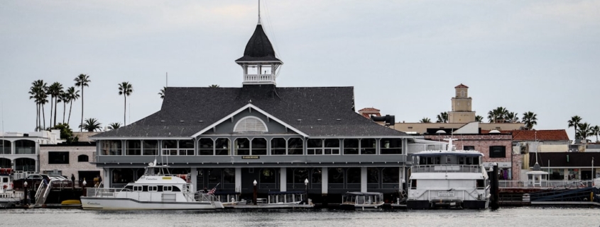 a boat dock with a building and a flag on top of it