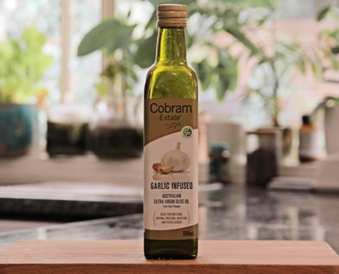 a bottle of garlic oil sitting on top of a counter