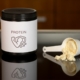 a container of protein powder next to a spoon