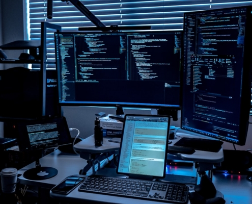 a desk with several monitors