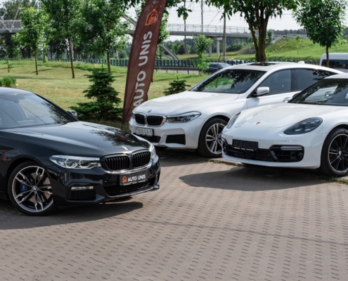 a group of cars parked on a brick road