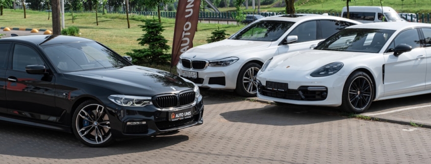 a group of cars parked on a brick road