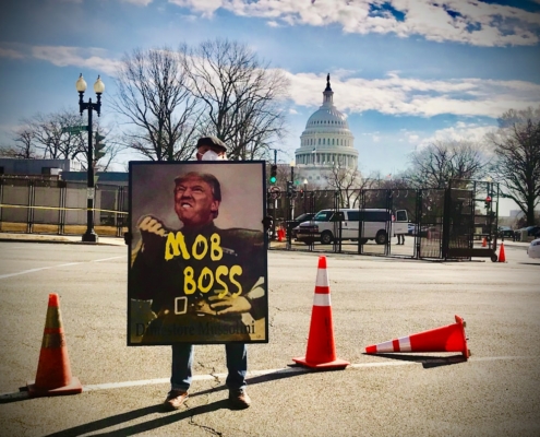 a man holding a sign with a picture of a man on it