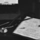 a notebook with a stethoscope on top of it next to a laptop