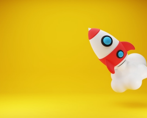 a red and white toy rocket on a yellow background