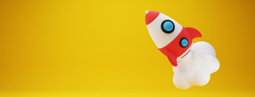 a red and white toy rocket on a yellow background