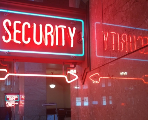 a red security sign and a blue security sign