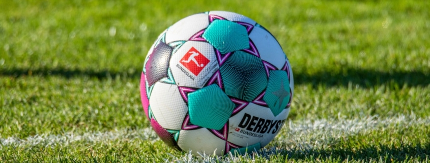 a soccer ball sitting on top of a lush green field