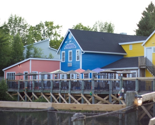 blue and white wooden house near body of water during daytime