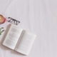 book page beside eyeglasses and coffee