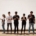 group of people standing on brown floor