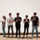 group of people standing on brown floor