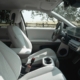 Interior view of a modern car with white seats.