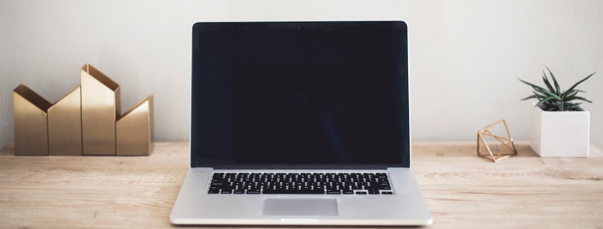 MacBook Pro on top of brown table