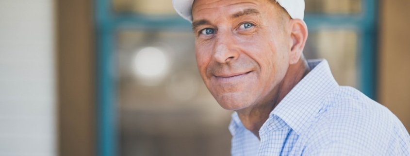 man smiling while sitting