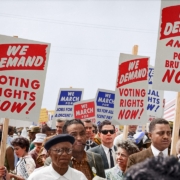 Marchers holding signs demanding the right to vote at the March on Washington