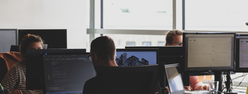 people sitting on chair in front of computer monitor