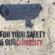 Security camera stencil with text on wall