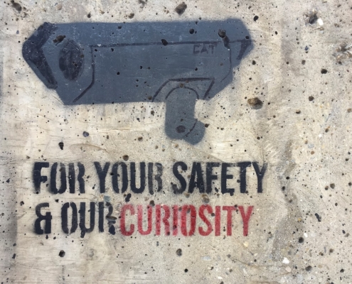 Security camera stencil with text on wall