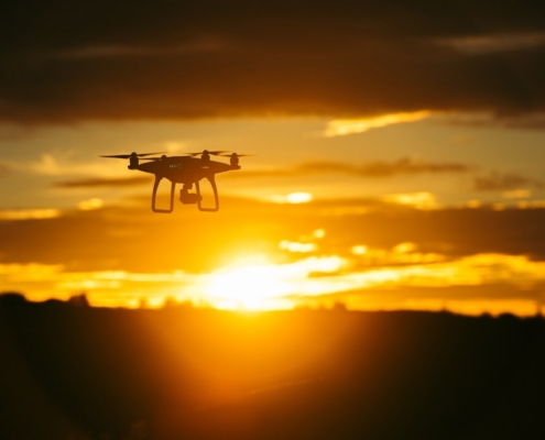 silhouette camera drone flying midair