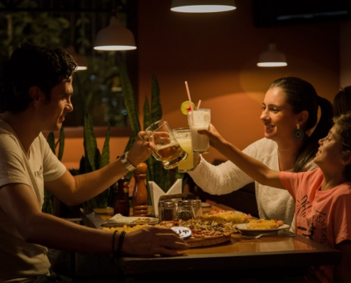 three people having a toast on table