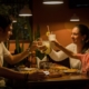 three people having a toast on table