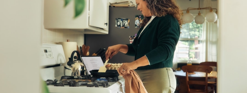 Woman cooking on a stovetop in a kitchen